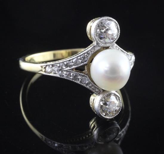 A 1920s gold, natural pearl and two stone diamond upfinger dress ring, size P.